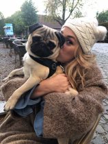 Happy dog rests in basket after successful babysitting day
